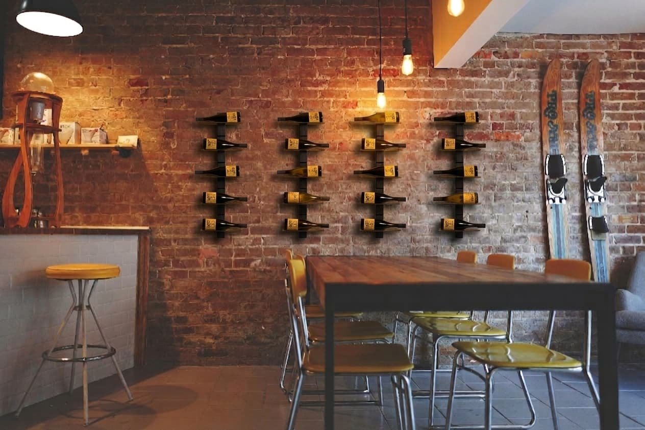 A steel wall shelf behind an industrial bar counter, with bottles displayed so that the labels face the room