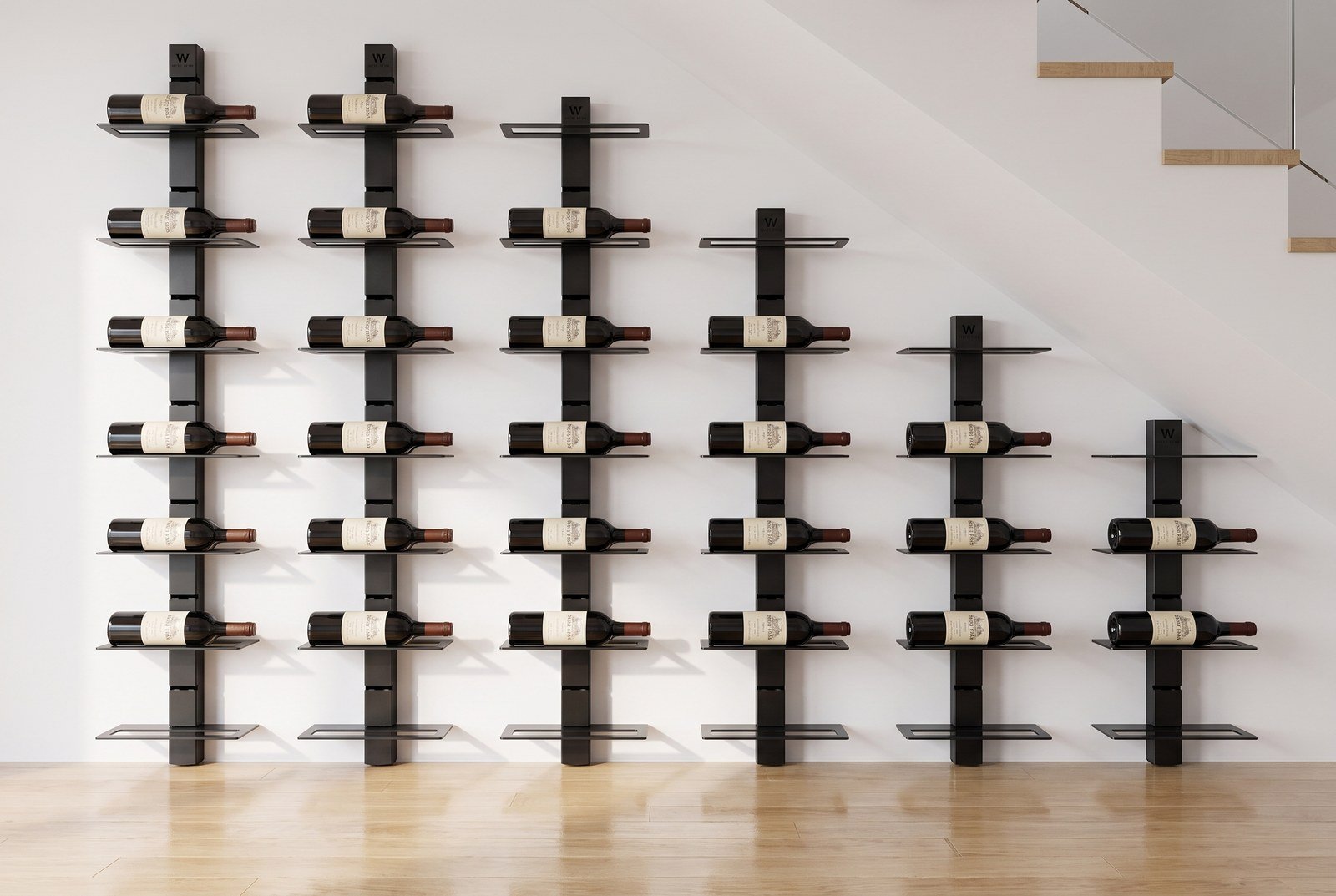 The space under the stairs has been converted into a wall of bottles arranged in descending columns, with the floor left clear